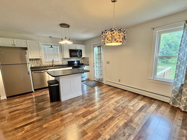 10 Turgeon St, Lewiston, ME 04240 - kitchen with appliances with stainless steel finishes, a baseboard radiator, dark countertops, white cabinets, and dark wood finished floors
