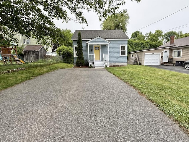 10 Turgeon St, Lewiston, ME 04240 - bungalow featuring driveway, a garage, a playground, and a shingled roof