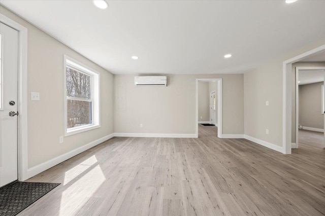 184 Jackson Rd, Waldoboro, ME 04572 - unfurnished living room featuring a wall mounted air conditioner, light wood finished floors, and recessed lighting