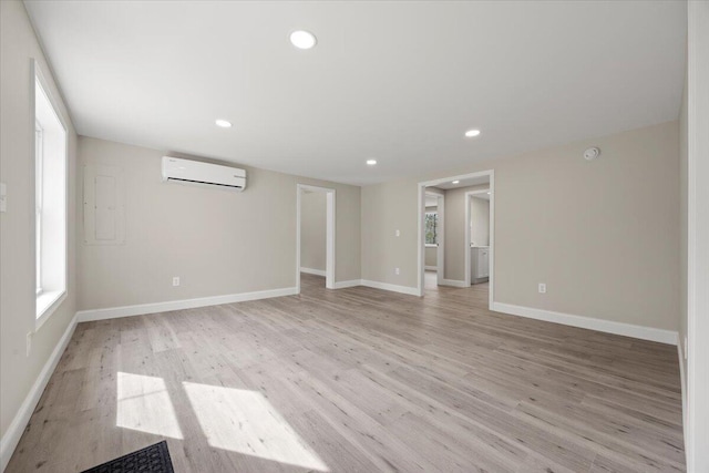 184 Jackson Rd, Waldoboro, ME 04572 - empty room with a wall unit AC, light wood-style flooring, recessed lighting, healthy amount of natural light, and electric panel