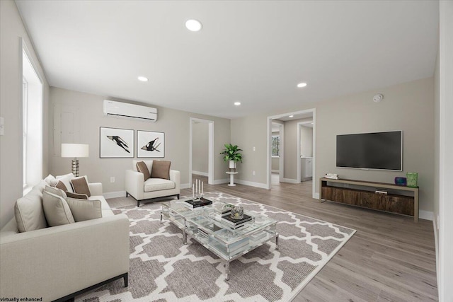184 Jackson Rd, Waldoboro, ME 04572 - living room featuring a wall mounted air conditioner, light wood-style flooring, recessed lighting, and healthy amount of natural light