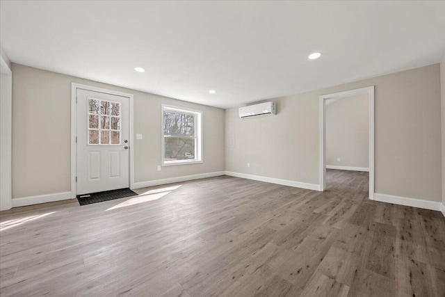 184 Jackson Rd, Waldoboro, ME 04572 - foyer entrance with wood finished floors, a wall mounted AC, and recessed lighting