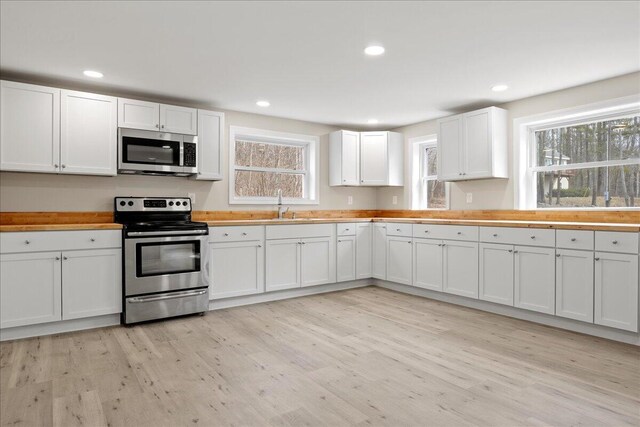 184 Jackson Rd, Waldoboro, ME 04572 - kitchen with stainless steel appliances, light wood-style floors, white cabinetry, recessed lighting, and wooden counters