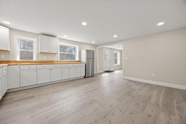184 Jackson Rd, Waldoboro, ME 04572 - kitchen with freestanding refrigerator, light wood-style floors, white cabinets, healthy amount of natural light, and recessed lighting