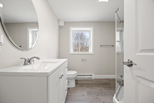 184 Jackson Rd, Waldoboro, ME 04572 - full bathroom featuring a baseboard heating unit, wood finished floors, vanity, and a shower