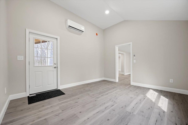 184 Jackson Rd, Waldoboro, ME 04572 - foyer featuring a wall unit AC, wood finished floors, and lofted ceiling