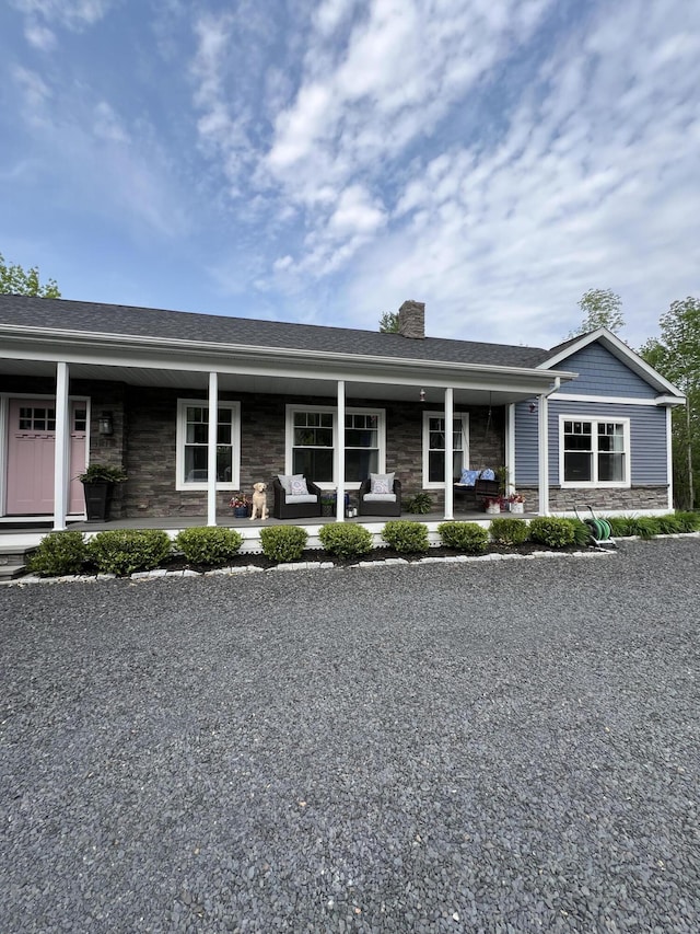 72 Cedar St, Calais, ME 04619 - ranch-style house featuring stone siding, a chimney, and covered porch