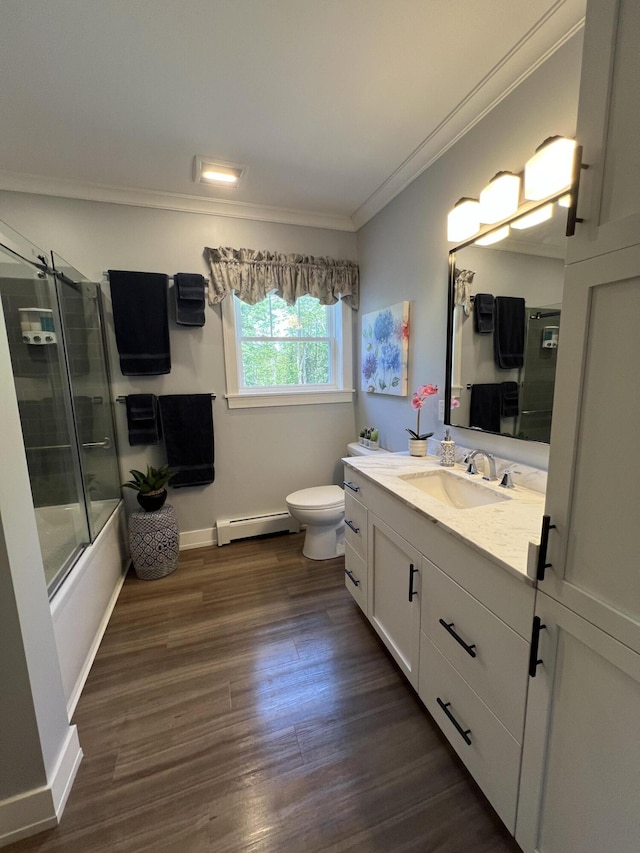 72 Cedar St, Calais, ME 04619 - bathroom with a baseboard heating unit, ornamental molding, vanity, wood finished floors, and bath / shower combo with glass door