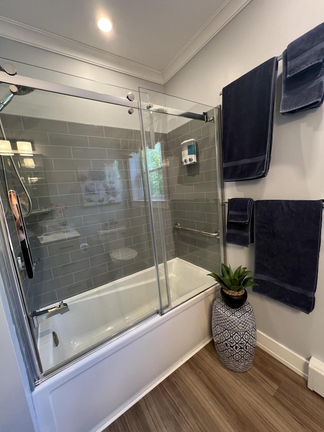 72 Cedar St, Calais, ME 04619 - bathroom featuring ornamental molding, wood finished floors, and enclosed tub / shower combo