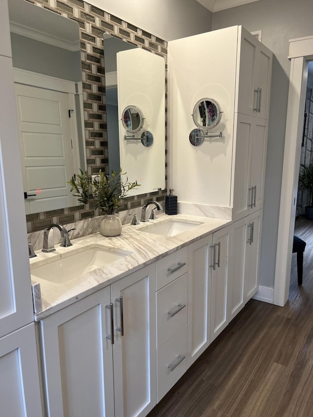72 Cedar St, Calais, ME 04619 - bathroom featuring wood finished floors, double vanity, and crown molding