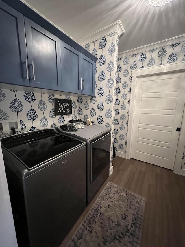 72 Cedar St, Calais, ME 04619 - laundry area featuring washer and dryer, dark wood-style floors, wallpapered walls, cabinet space, and ornamental molding