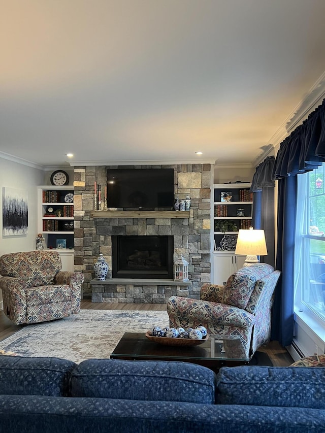 72 Cedar St, Calais, ME 04619 - living area featuring ornamental molding, wood finished floors, a stone fireplace, built in features, and a baseboard heating unit