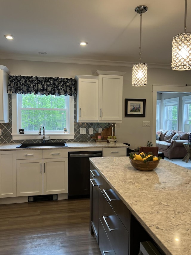 72 Cedar St, Calais, ME 04619 - kitchen with stainless steel dishwasher, crown molding, plenty of natural light, white cabinetry, and decorative backsplash