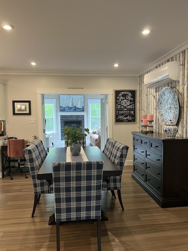 72 Cedar St, Calais, ME 04619 - dining room featuring a wall unit AC, crown molding, plenty of natural light, dark wood-style flooring, and a fireplace