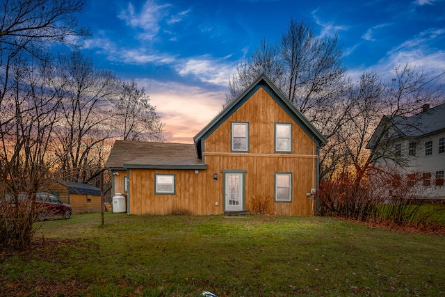 30 Troy Rd, Burnham, ME 04922 - back of house at dusk with a lawn and roof with shingles