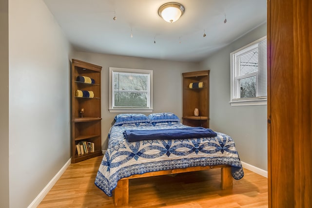 30 Troy Rd, Burnham, ME 04922 - bedroom featuring multiple windows and light wood-type flooring