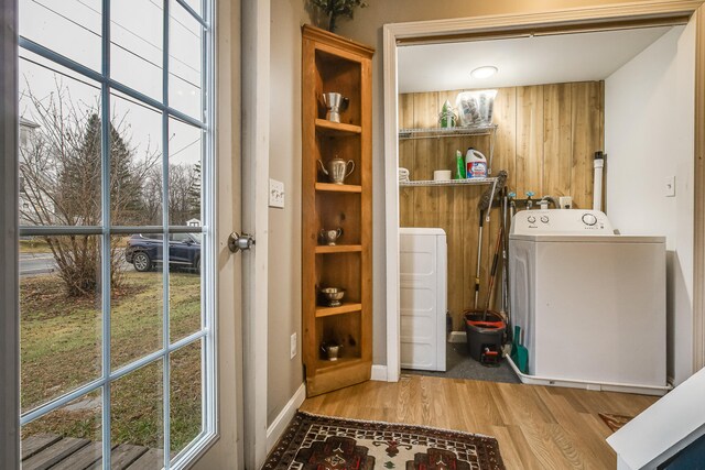 30 Troy Rd, Burnham, ME 04922 - laundry room featuring wood finished floors, plenty of natural light, washing machine and clothes dryer, and wood walls