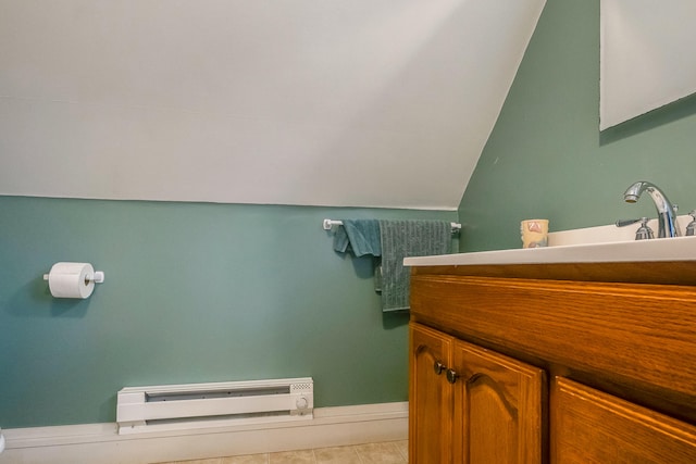 30 Troy Rd, Burnham, ME 04922 - bathroom with a baseboard heating unit, vanity, tile patterned flooring, and vaulted ceiling