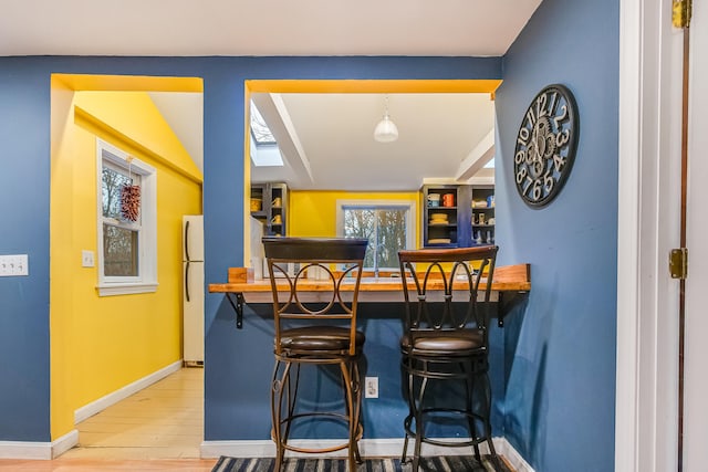 30 Troy Rd, Burnham, ME 04922 - indoor bar with wood finished floors and freestanding refrigerator