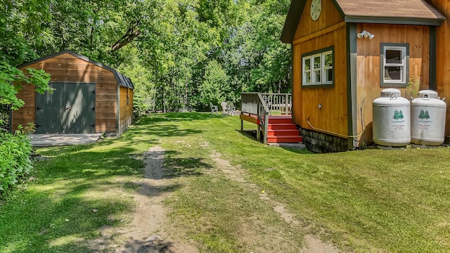 30 Troy Rd, Burnham, ME 04922 - view of green lawn with a storage unit and a wooden deck