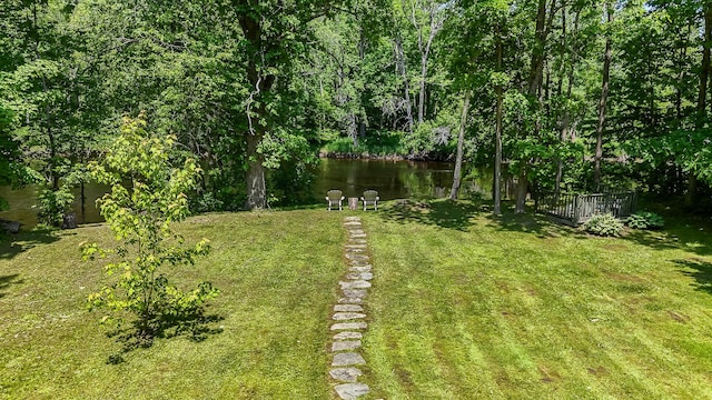 30 Troy Rd, Burnham, ME 04922 - view of green lawn featuring a deck with water view