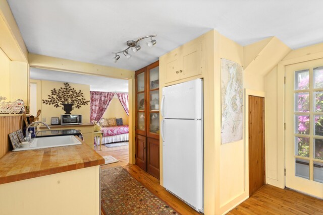 108 Colony Rd, Islesboro, ME 04848 - kitchen featuring freestanding refrigerator, light wood-style flooring, wooden counters, and healthy amount of natural light