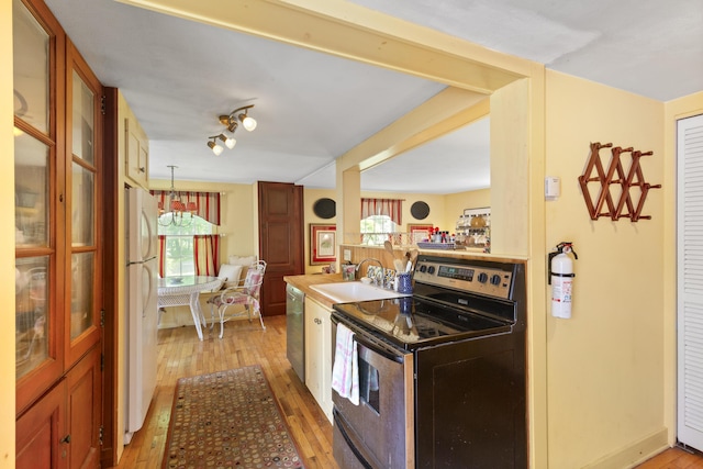 108 Colony Rd, Islesboro, ME 04848 - kitchen with stainless steel appliances, light wood-type flooring, and hanging light fixtures