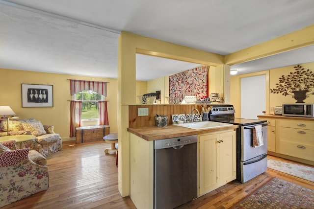 108 Colony Rd, Islesboro, ME 04848 - kitchen with stainless steel appliances, light wood-style floors, wood counters, and open floor plan