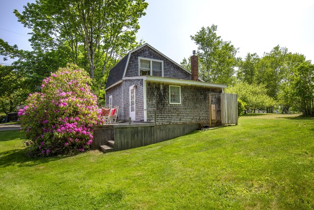 108 Colony Rd, Islesboro, ME 04848 - view of side of home with a chimney, a lawn, and a deck