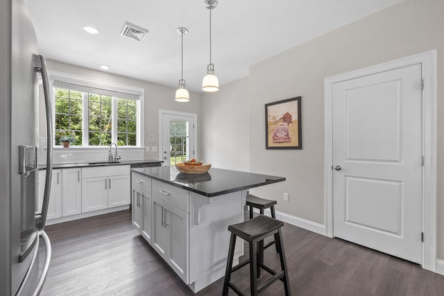 30 Pepperell Way Unit 58, Arundel, ME 04046 - kitchen featuring stainless steel fridge with ice dispenser, dark countertops, a breakfast bar, healthy amount of natural light, and recessed lighting