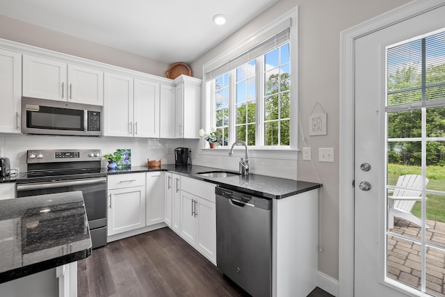 30 Pepperell Way Unit 58, Arundel, ME 04046 - kitchen featuring appliances with stainless steel finishes, white cabinets, tasteful backsplash, and dark stone countertops