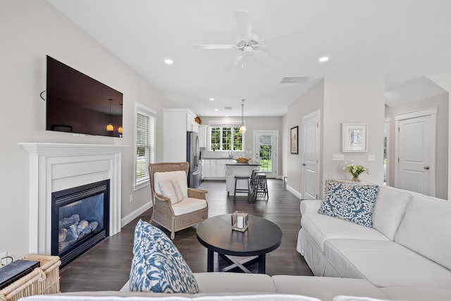 30 Pepperell Way Unit 58, Arundel, ME 04046 - living room with recessed lighting, dark wood-style floors, a ceiling fan, and a glass covered fireplace