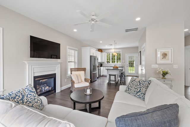 30 Pepperell Way Unit 58, Arundel, ME 04046 - living area with dark wood finished floors, a ceiling fan, a glass covered fireplace, and recessed lighting