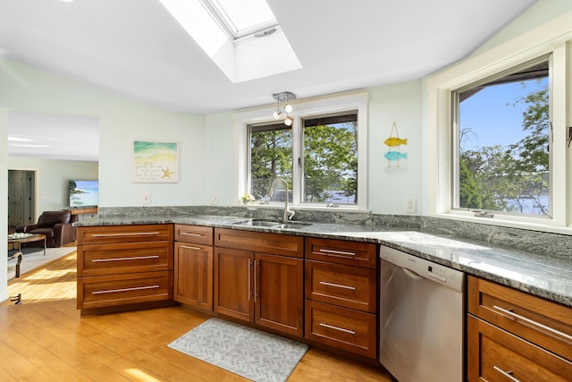 167 Hayden Point Rd, South Thomaston, ME 04858 - kitchen featuring dishwasher, a skylight, light wood finished floors, and dark stone countertops