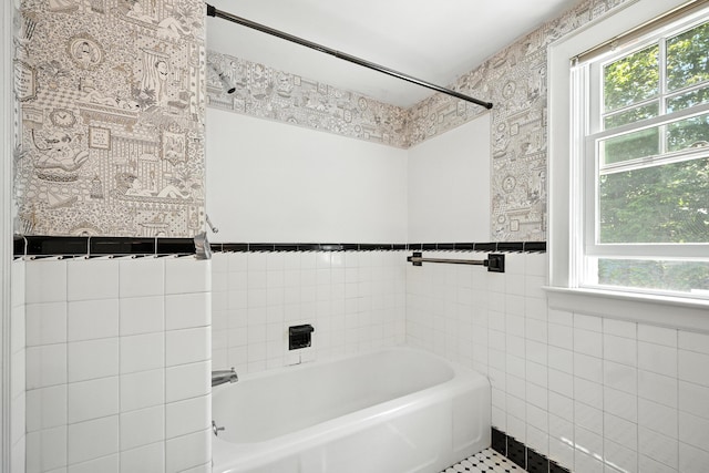 18 Fern Ave, Falmouth, ME 04105 - bathroom with tile walls, a bath, and plenty of natural light