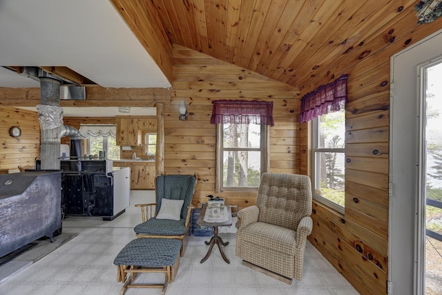 M18L1 Troutdale Rd, The Forks Plt, ME 04985 - living area with vaulted ceiling, light flooring, wood walls, a wood stove, and wooden ceiling