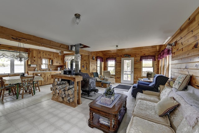 M18L1 Troutdale Rd, The Forks Plt, ME 04985 - living room featuring wood walls, healthy amount of natural light, and a wood stove