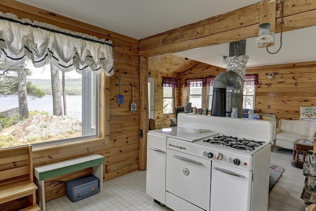 M18L1 Troutdale Rd, The Forks Plt, ME 04985 - kitchen featuring lofted ceiling, wood walls, light flooring, open floor plan, and white cabinetry