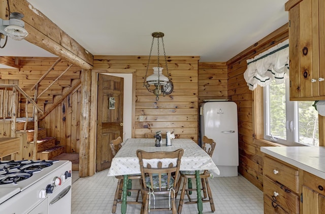 M18L1 Troutdale Rd, The Forks Plt, ME 04985 - dining room with wood walls, light floors, and stairs