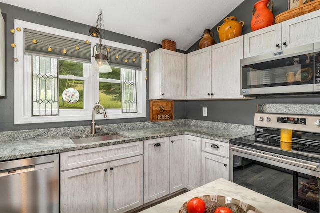 25 Riverview Dr Unit D, North Berwick, ME 03906 - kitchen with stainless steel appliances, vaulted ceiling, stone countertops, pendant lighting, and wood finished floors
