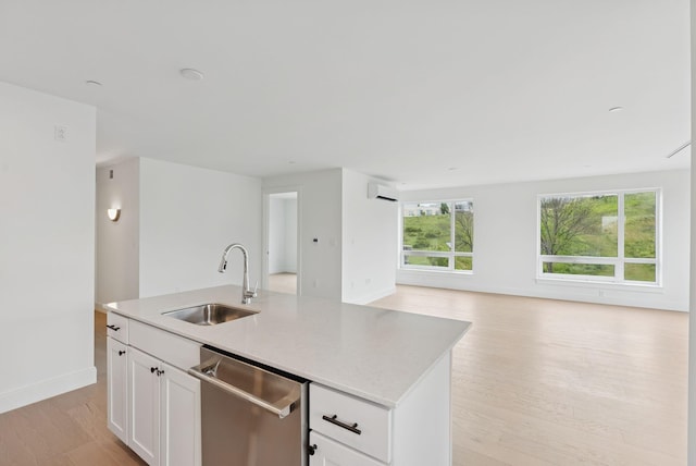 218 Washington Ave Unit 207, Portland, ME 04101 - kitchen with dishwasher, open floor plan, light wood finished floors, white cabinets, and an island with sink
