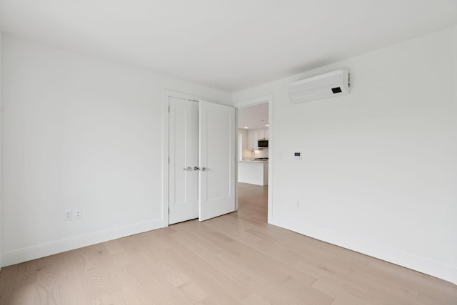 218 Washington Ave Unit 207, Portland, ME 04101 - spare room with an AC wall unit and light wood-style flooring