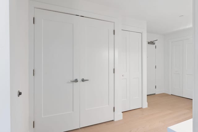 218 Washington Ave Unit 207, Portland, ME 04101 - unfurnished bedroom with multiple closets and light wood-style floors