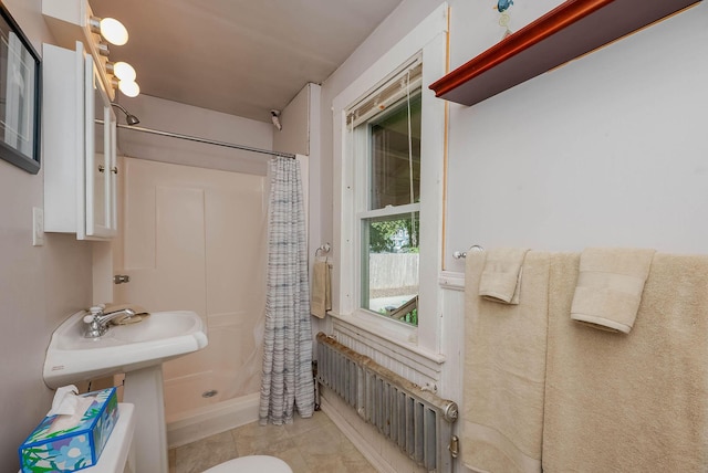 12 Court St, Rochester, NH 03867 - bathroom featuring a shower stall, tile patterned floors, and radiator heating unit