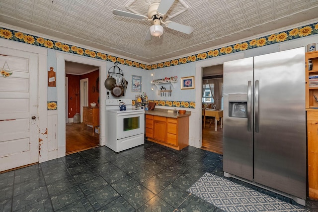 12 Court St, Rochester, NH 03867 - kitchen featuring stainless steel refrigerator with ice dispenser, electric range, ceiling fan, dark flooring, and an ornate ceiling