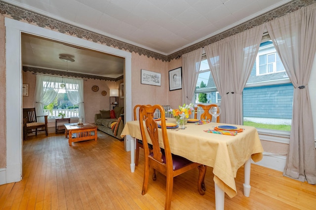 12 Court St, Rochester, NH 03867 - dining area featuring light wood finished floors, ornamental molding, and wallpapered walls