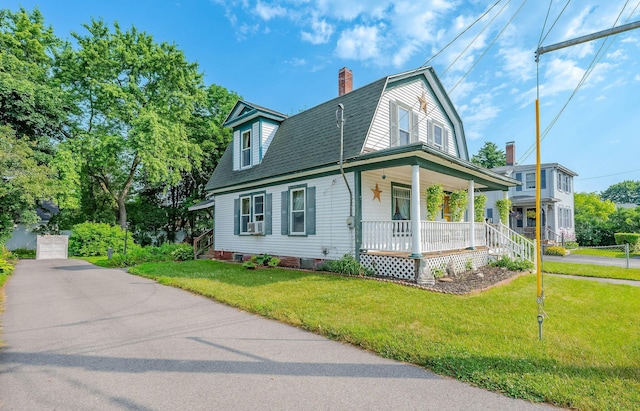 12 Court St, Rochester, NH 03867 - view of front facade with covered porch, a chimney, a gambrel roof, and a front yard