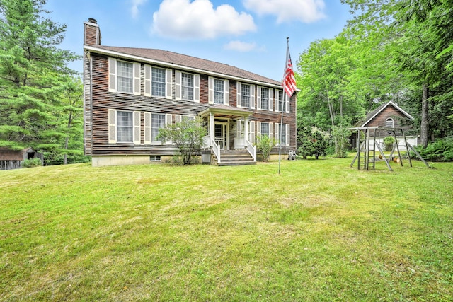 15 Loon Call Dr, Belgrade, ME 04917 - back of property with a chimney, a yard, and a playground
