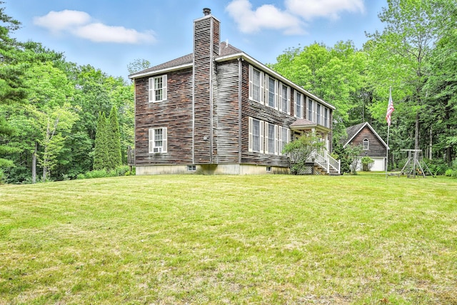 15 Loon Call Dr, Belgrade, ME 04917 - view of side of home featuring a yard and a chimney