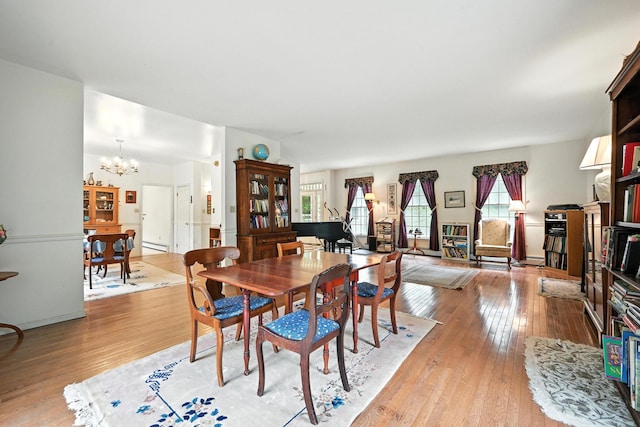 15 Loon Call Dr, Belgrade, ME 04917 - dining space with light wood-type flooring, a chandelier, and baseboard heating